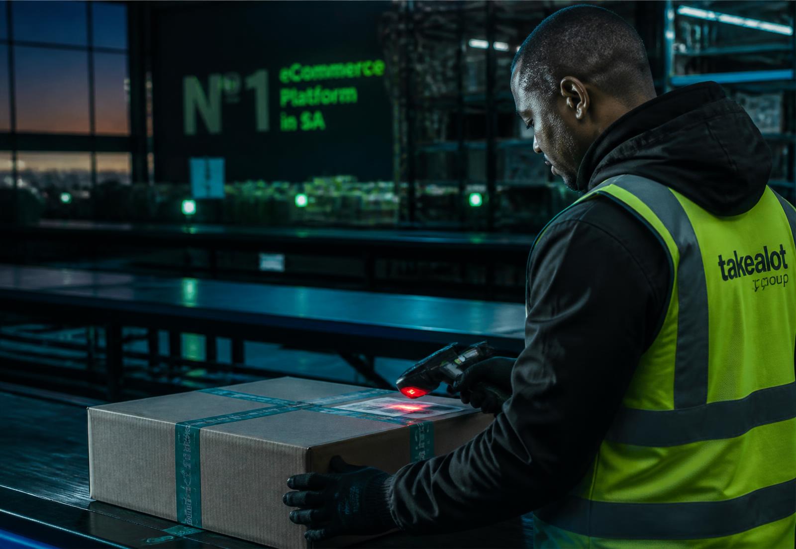 Operator scanning a tamper-sealed parcel on a fulfilment centre line